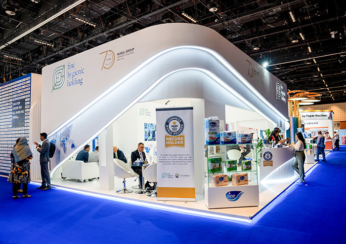 Two builders on-site securing a fitting during exhibition stand construction